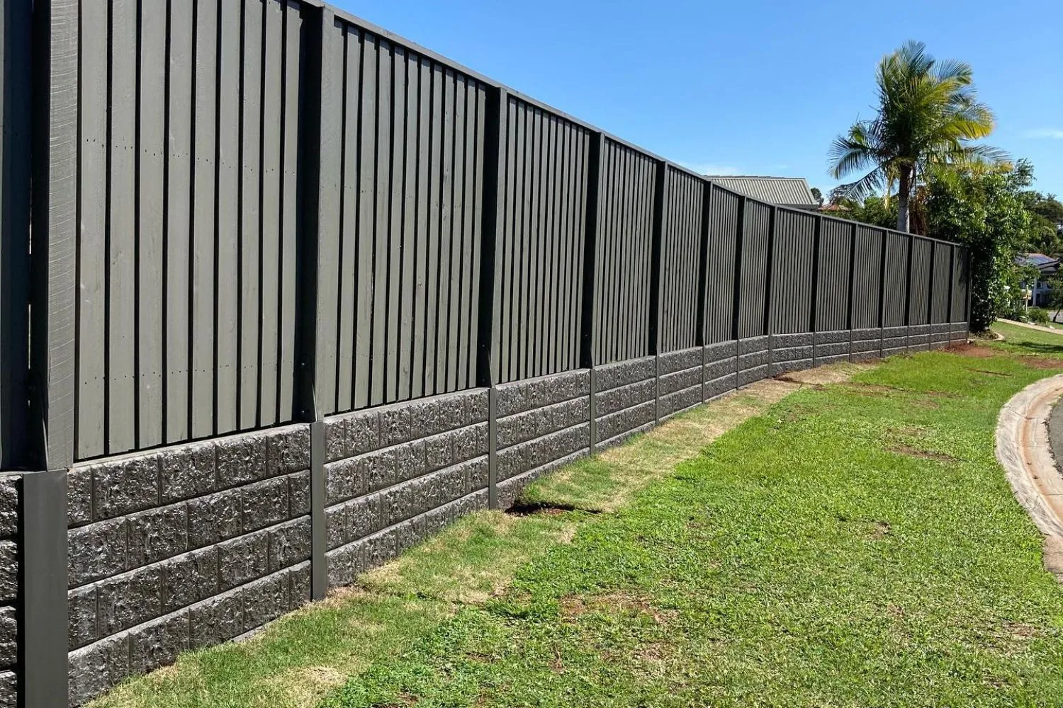 Concrete sleeper retaining wall with palm tree